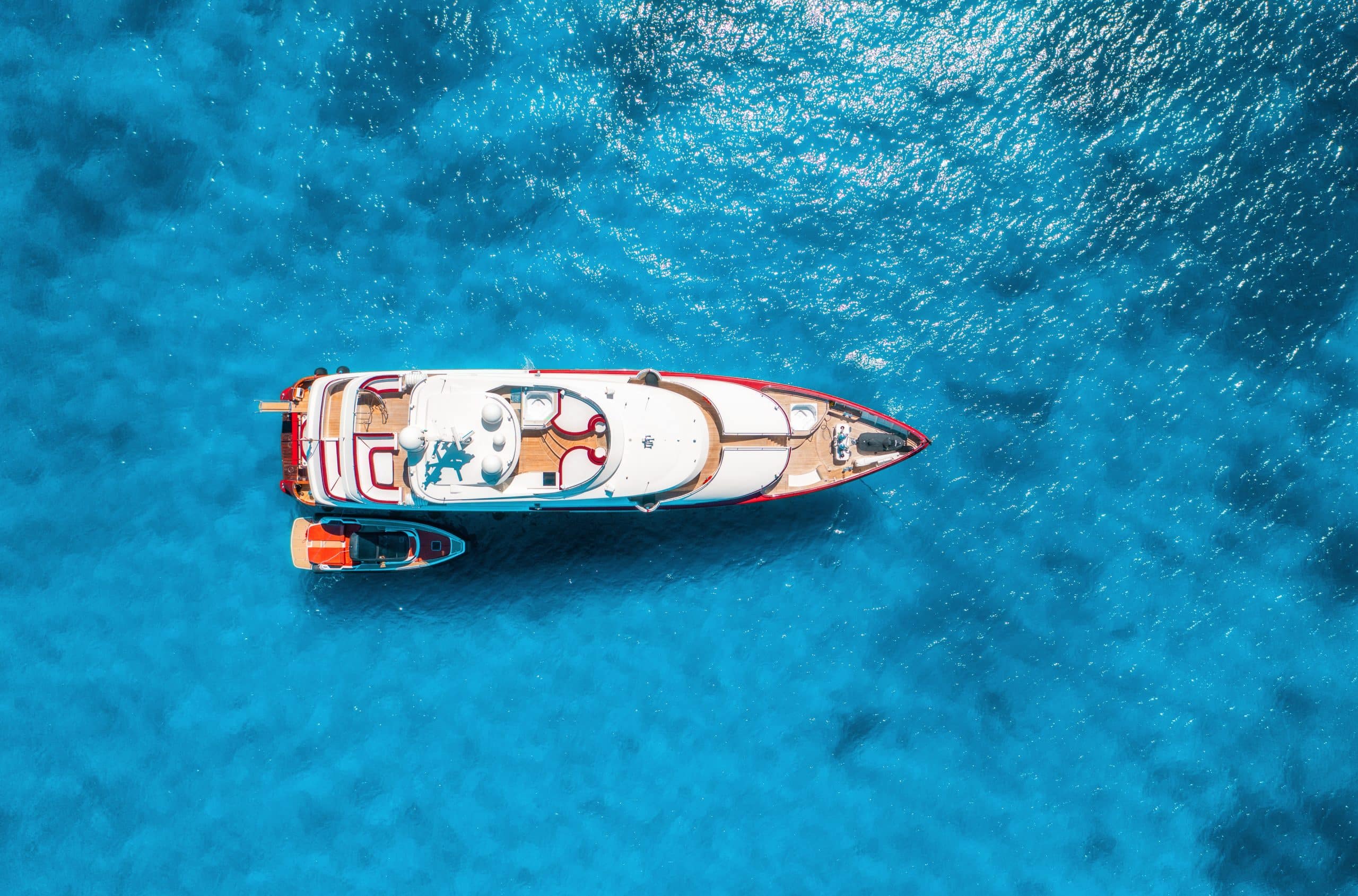 Aerial view of a luxury yacht anchored in clear blue water